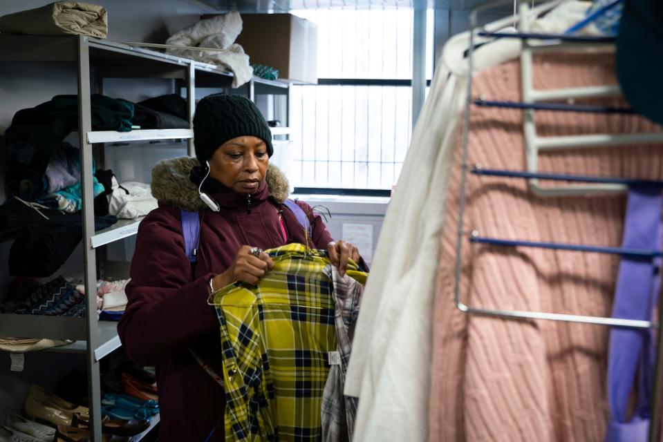 Tonya Hogan, 50, looks through donated clothing at Crossroads, an outreach agency in Detroit on Thursday, Feb. 23, 2023.