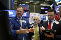Specialist Charles Boeddinghaus, left, works with traders Peter Tuchman, center, and Frank Masiello on the floor of the New York Stock Exchange, Friday, Nov. 9, 2018. Stocks are falling as energy companies are dragged lower by the continuing plunge in crude oil prices. (AP Photo/Richard Drew)