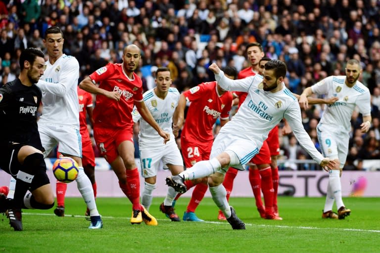 Real Madrid's Spanish defender Nacho (front R) scores a goal against Sevilla at the Santiago Bernabeu Stadium in Madrid on December 9, 2017