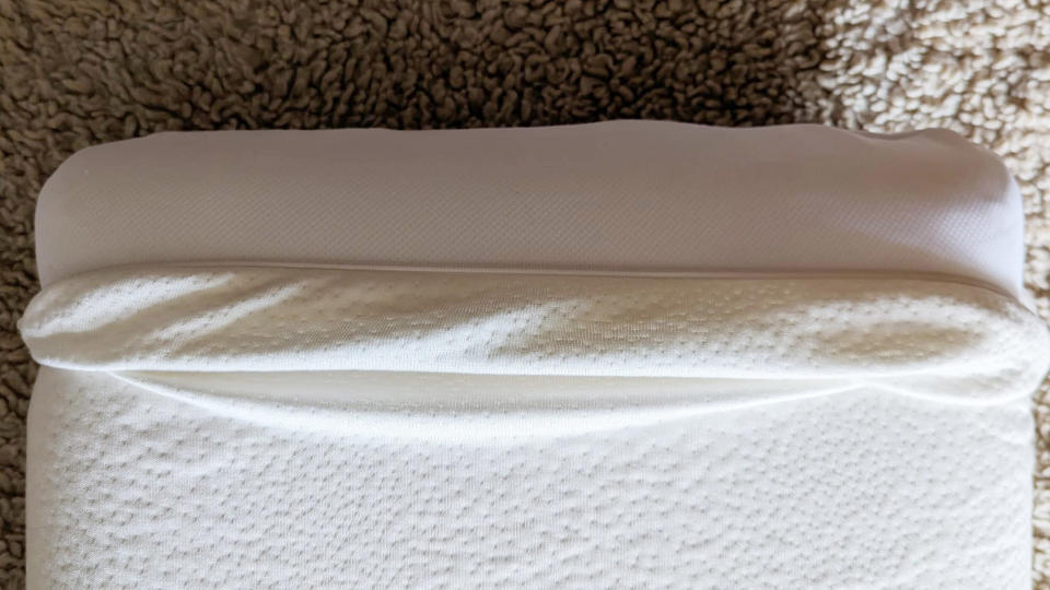 The Panda Memory Foam Bamboo Pillow with its cover pulled back to show the fill