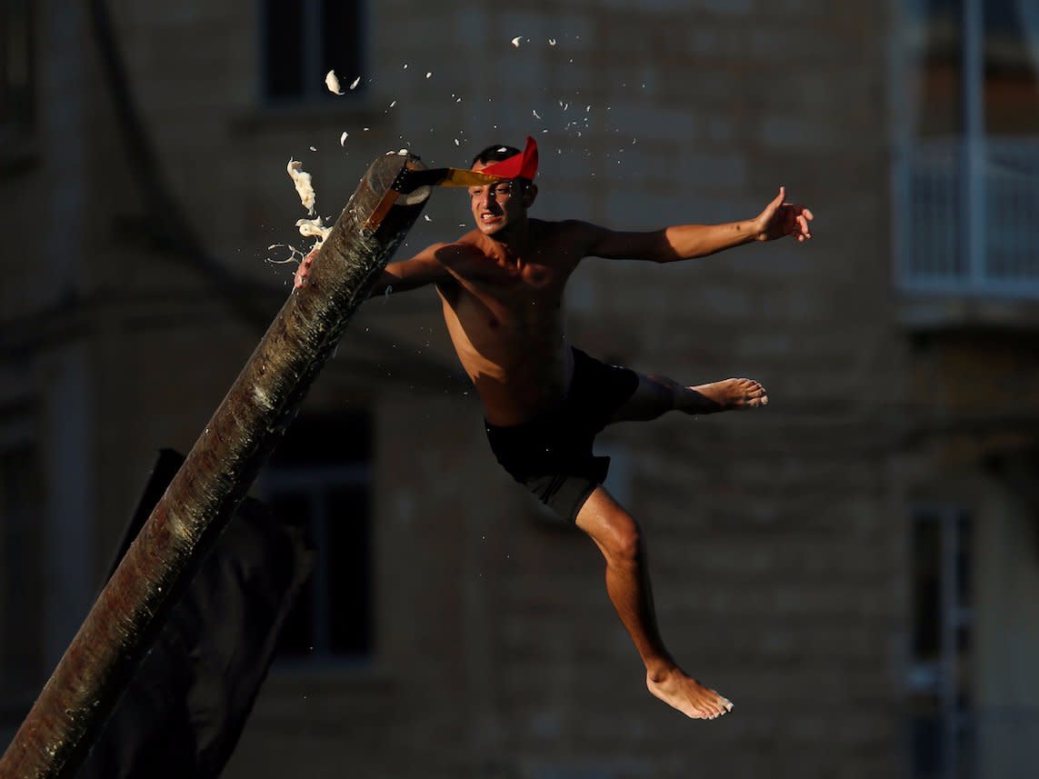 A man swipes grease after slipping off the