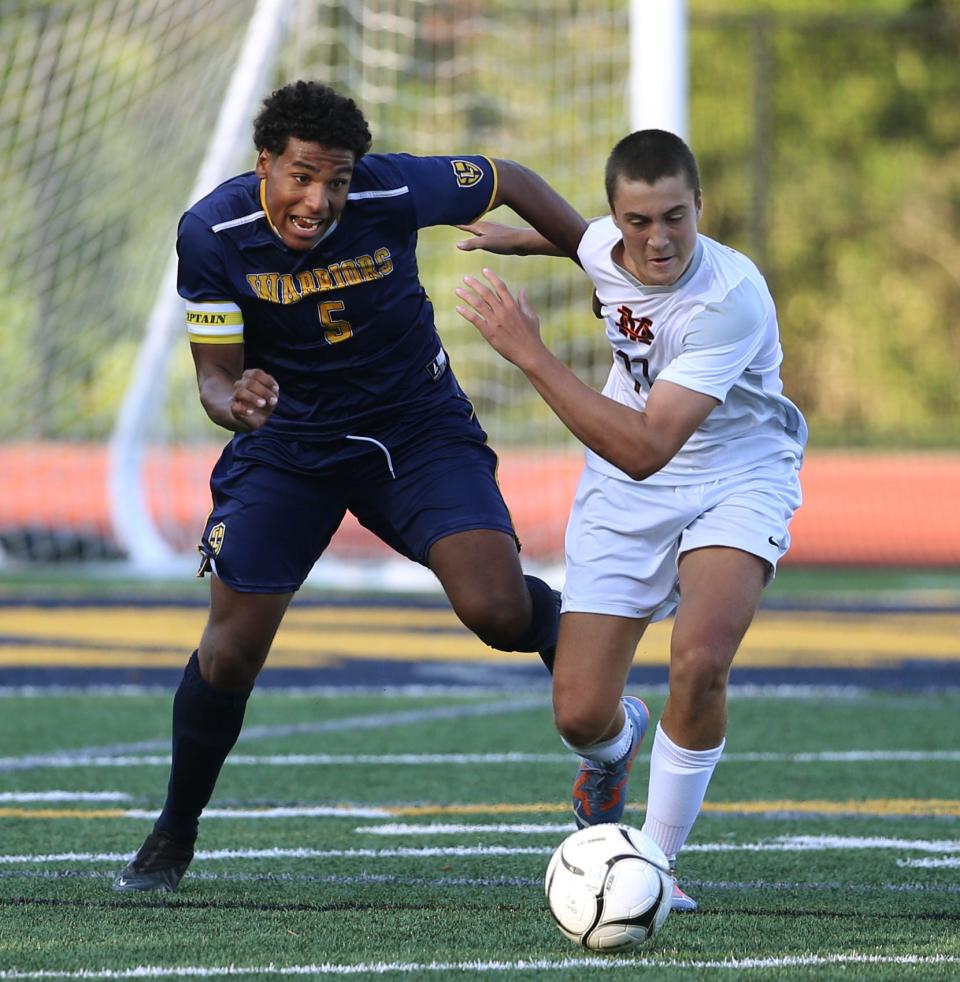 Lourdes' Alex Crysler (left) and Marlboro's Jake Brown fight for the ball in September.