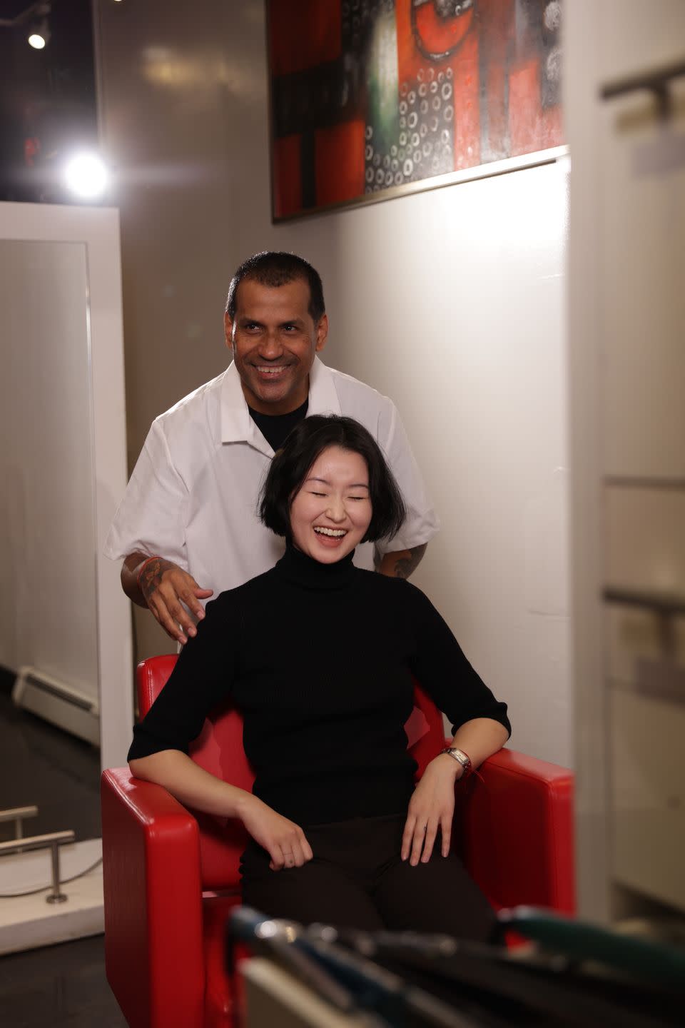 a man and woman sitting on a red chair