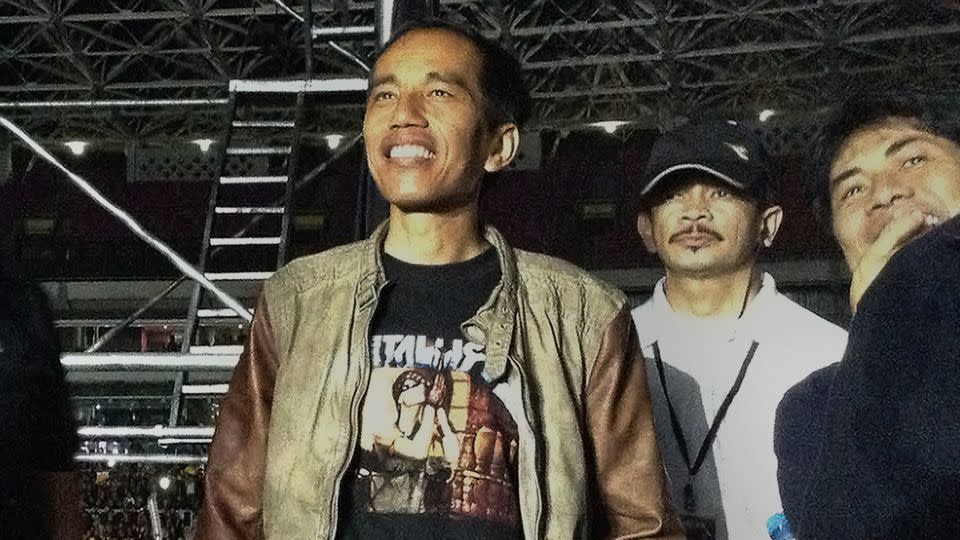 In this photograph taken on August 25, 2013, then-Jakarta governor Joko Widodo, watches a Metallica concert at the Bung Karno stadium in Jakarta. - Olivia Rondonuwu/AFP/Getty Images