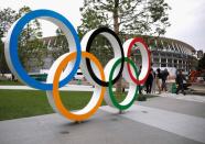 Olympic rings are displayed in front of the construction site of the New National Stadium, the main stadium of Tokyo 2020 Olympics and Paralympics, during a media opportunity in Tokyo