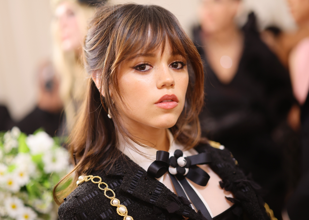 Jenna Orgega in a black dress with gold detailing and an abstract black bowtie.