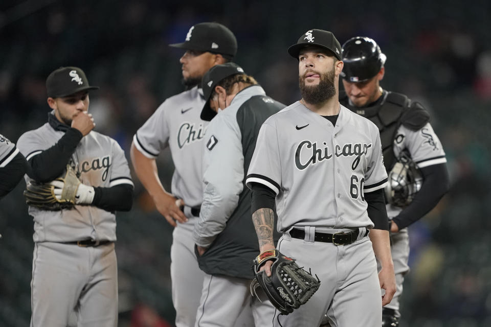 Chicago White Sox starting pitcher Dallas Keuchel, right, walks off the mound after being pulled during the sixth inning of a baseball game against the Seattle Mariners, Wednesday, April 7, 2021, in Seattle. (AP Photo/Ted S. Warren)