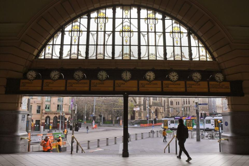 A commuter exits the usually bustling Flinders Street station in Melbourne on July 10, 2020, as the city re-enters a lockdown after a fresh outbreak of the COVID-19 coronavirus. - Australia will slash the number of returning citizens allowed into the country by half as it struggles to contain an outbreak of coronavirus in its second-largest city, officials announced on July 10. (Photo by William WEST / AFP) (Photo by WILLIAM WEST/AFP via Getty Images)