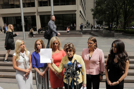 Attorney Gloria Allred holds a letter that she will deliver to the NFL on behalf of several former Houston Texans cheerleaders while speaking with fellow attorney Kimberley Spurlock outside of NFL headquarters in New York, U.S., June 4, 2018. REUTERS/Lucas Jackson