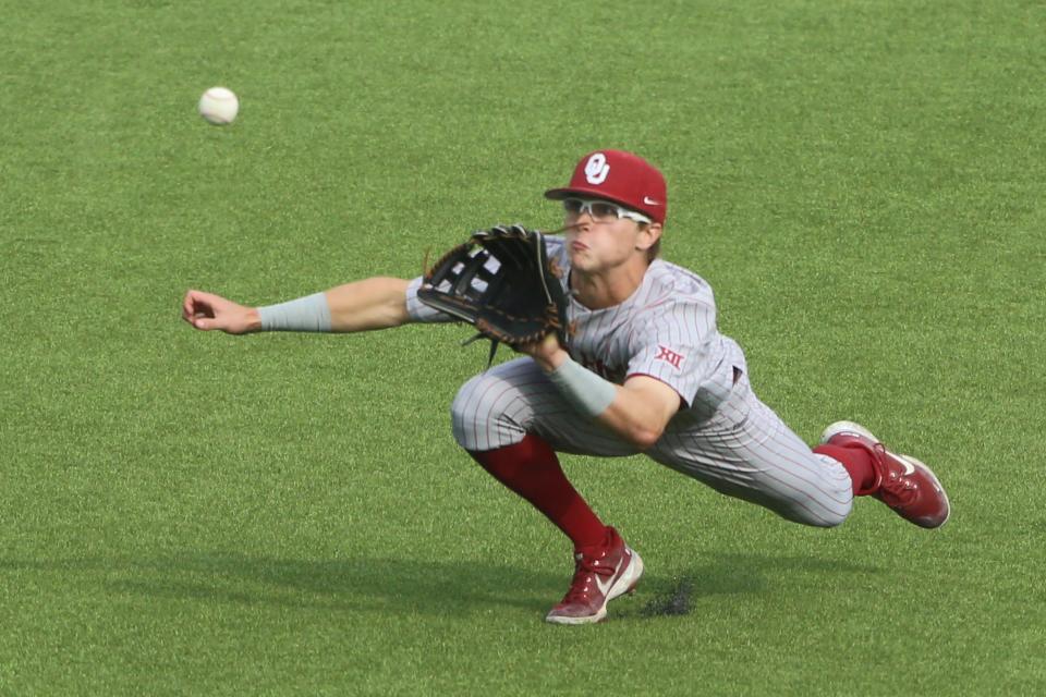 OU's John Spikerman (8) catches a fly ball in right field for the final out at Virginia Tech in a 5-4 win Friday.