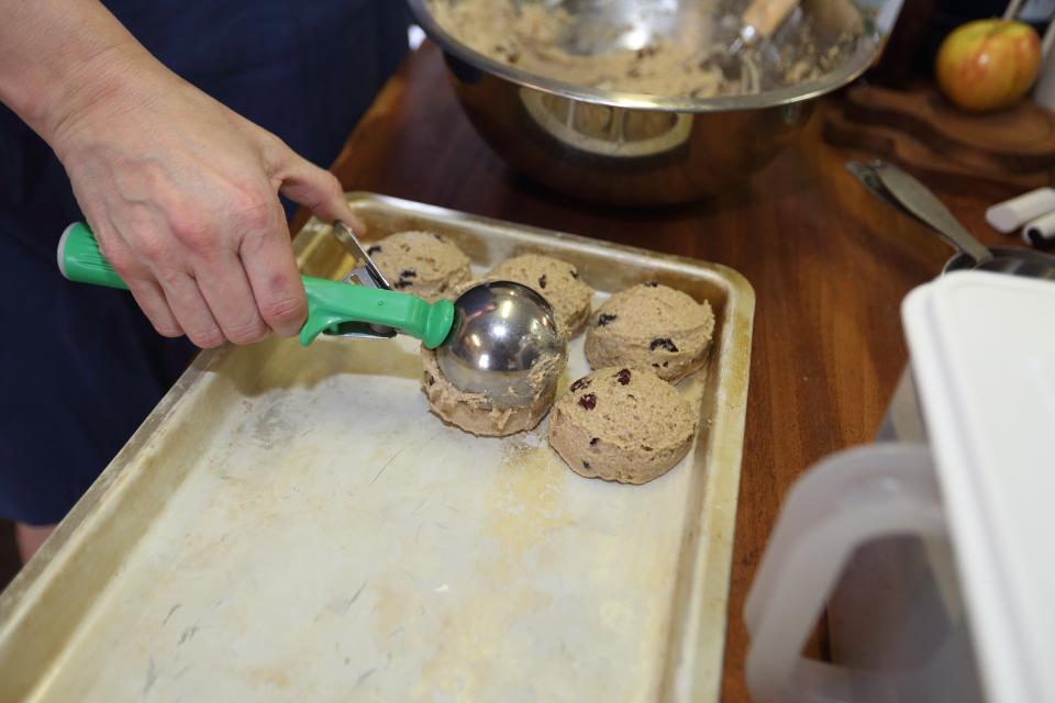 Knosh Columbus owner Susan Fisher scoops out cookie dough April 25 at the Ohio Village kitchen she uses for her commercial baking company.