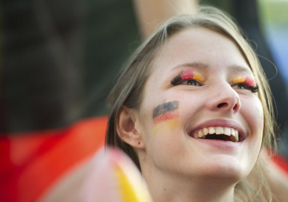 A fan celebrates after the 2014 World Cup quarter-final soccer match between Germany and France at the Fanmeile public viewing arena in Berlin July 4, 2014. REUTERS/Steffi Loos