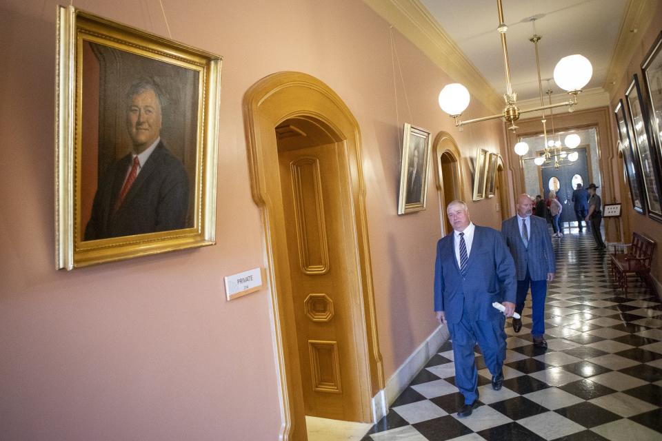 Rep. Larry Householder walks past his portrait after being expelled from the Ohio House at the Ohio Statehouse in Columbus on Wednesday, June 16, 2021.
