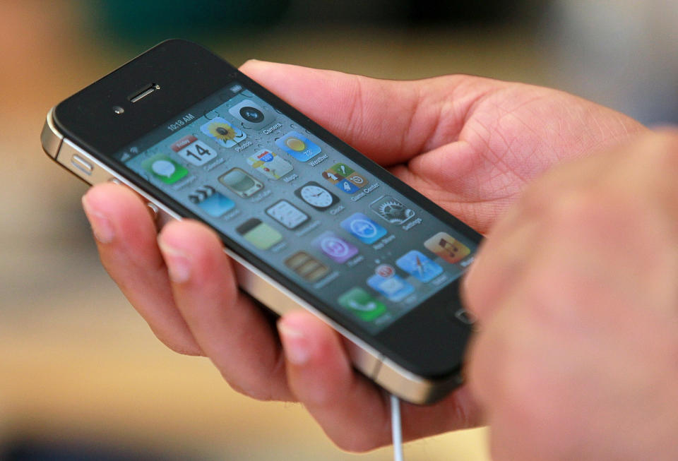 SAN FRANCISCO, CA - OCTOBER 14: An Apple Store customer looks at the new Apple iPhone 4Gs on October 14, 2011 in San Francisco, United States. The new iPhone 4Gs went on sale today and features a faster dual-core A5 chip, an 8MP camera that shoots 1080p HD video, and a voice assistant program. (Photo by Justin Sullivan/Getty Images)