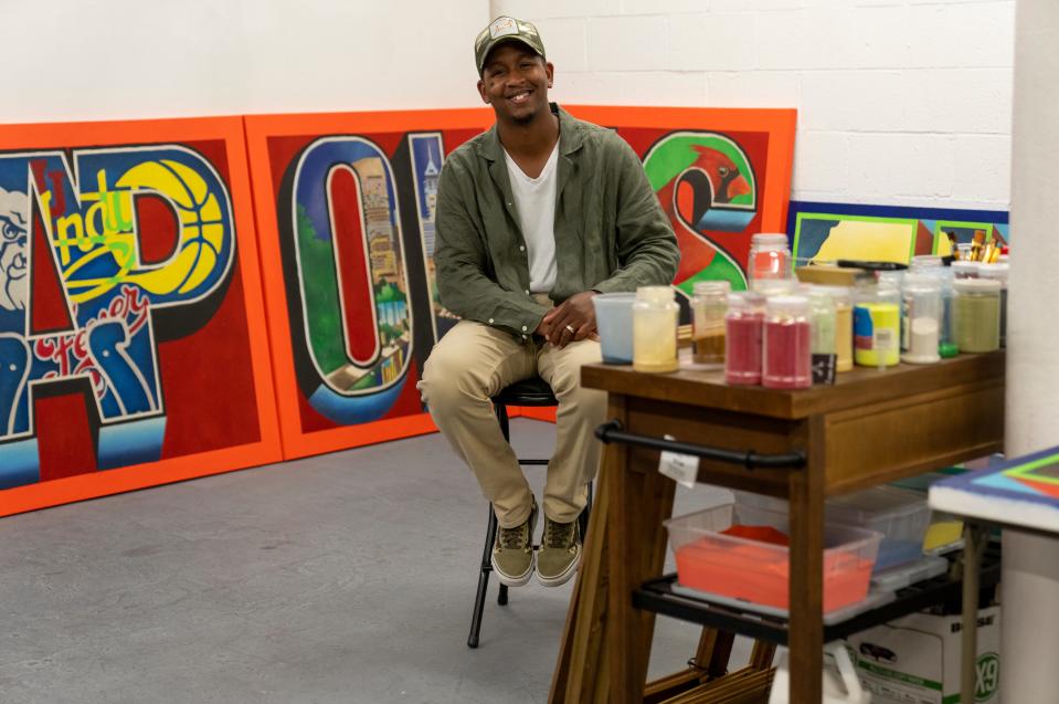 Derrick Carter with art work he’s creating in his studio at Harrison Center, Indianapolis, Thursday, July 14, 2022.