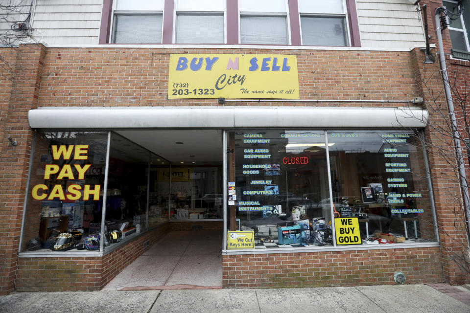 This Sunday, Dec. 15, 2019 photo shows the family-owned Buy n Sell pawn shop searched by the FBI over the weekend in Keyport, N.J. A New Jersey man whose number was found in the back pocket of one of the perpetrators of last week's fatal attack on a Jewish market has been arrested for illegally possessing a weapon. The number belonged to Ahmed A-Hady, and the address was for a storefront for the pawnshop. (Ed Murray/NJ Advance Media via AP)