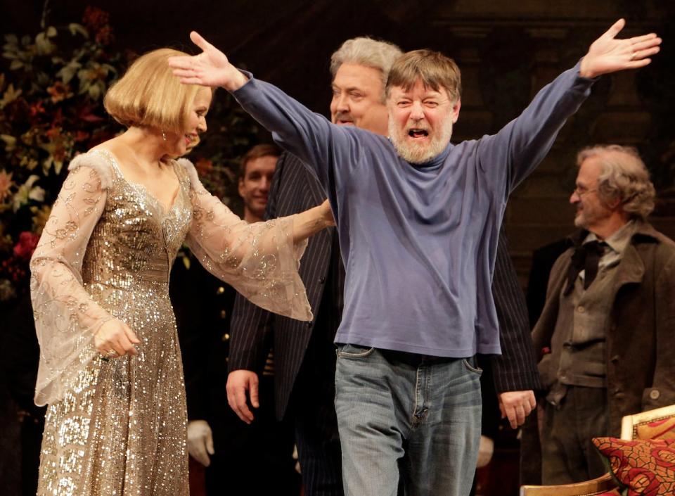 FILE - Conductor Andrew Davis, right, raises his arms as he takes a bow, accompanied by Renee Fleming, and Peter Rose, center, during the final dress rehearsal of Richard Strauss's "Capriccio" in the Metropolitan Opera at New York's Lincoln Center, March 25, 2011. Davis, the acclaimed British conductor who was music director of the Lyric Opera of Chicago and orchestras on three continents, has died, Saturday, April 20, 2024. He was 80.  