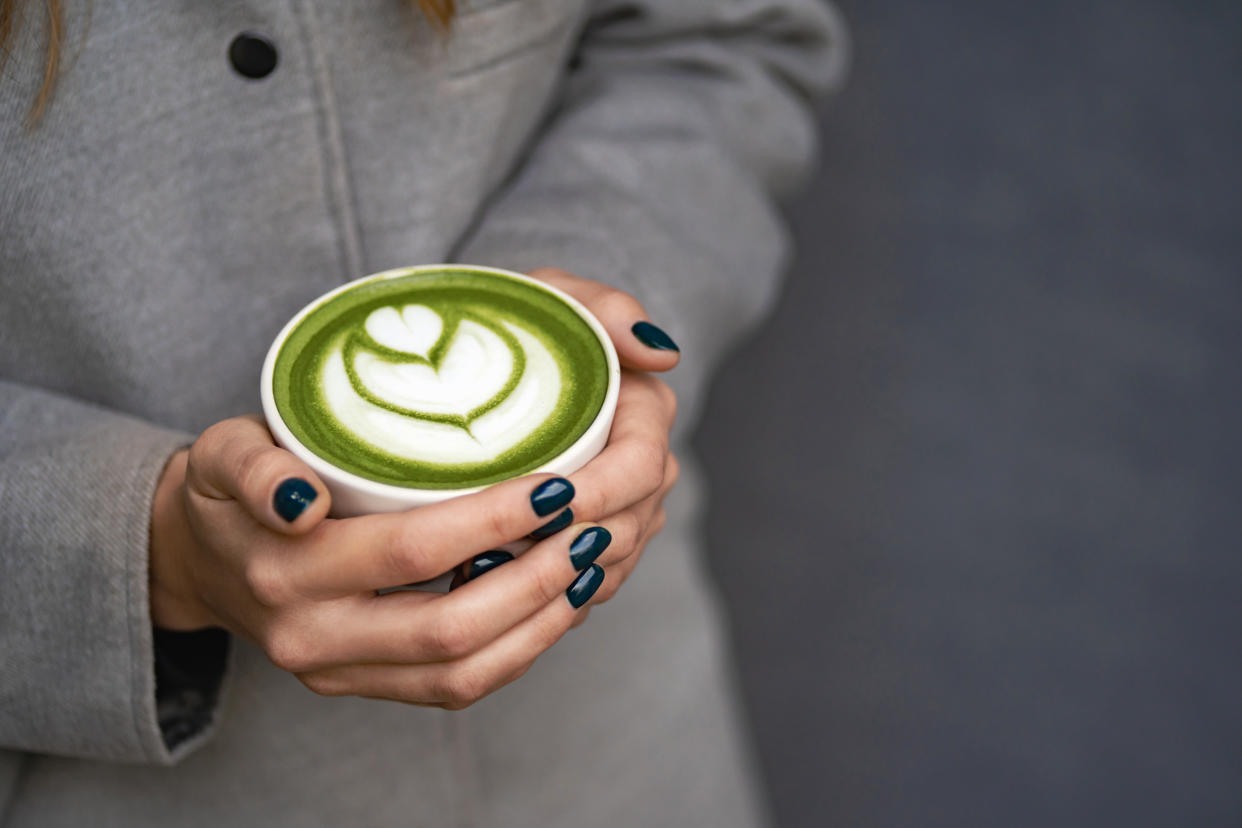 Woman holding a matcha tea. (Getty Images)