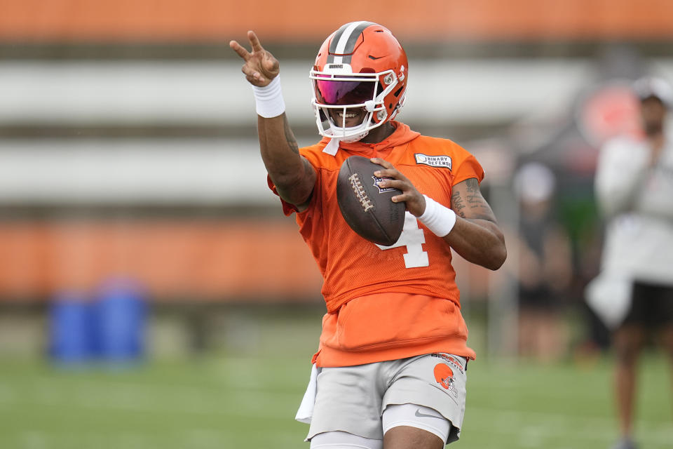 Cleveland Browns quarterback Deshaun Watson simulates throwing a pass during NFL football practice in Berea, Ohio, Wednesday, May 22, 2024. He took part in most of the drills on the second day of organized team activities (OTAs) but didn't do any passing. (AP Photo/Sue Ogrocki)