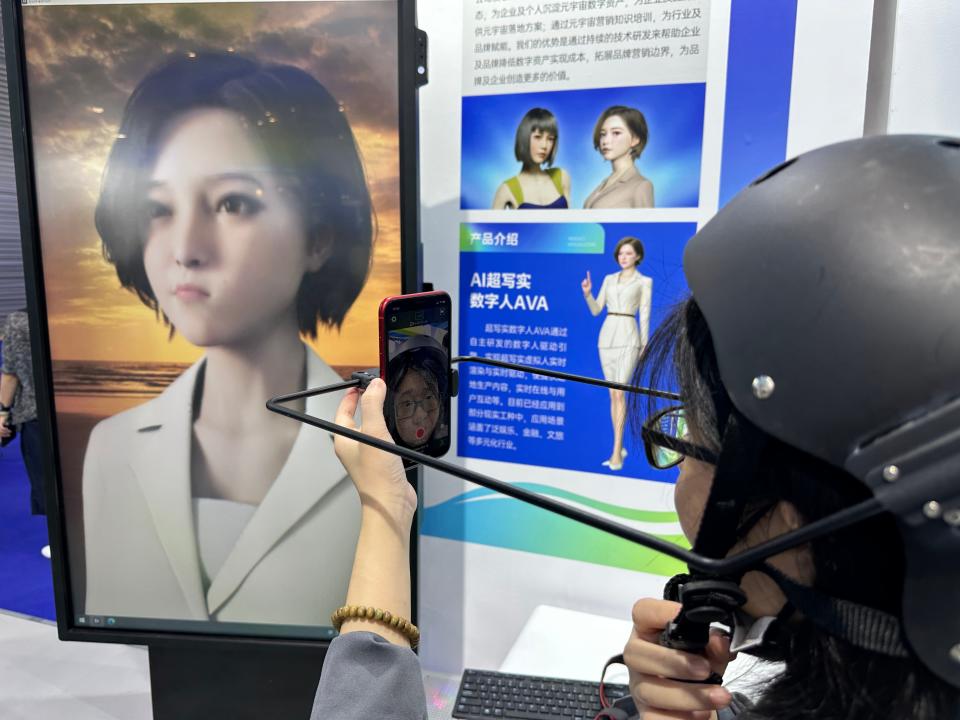 AI-powered digital assistants have been wildly popular in China. Here, a company is showcasing a "digital human" named AVA to tech fair visitors.