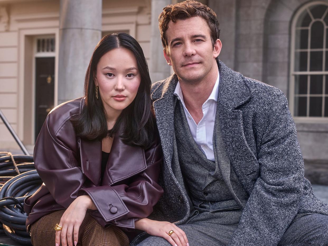 Yerin Ha and Luke Thompson photographed on the backlot of season four of "Bridgerton."