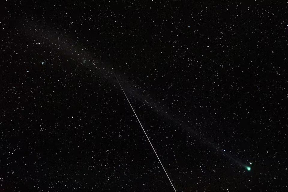 a green streak of light zooms between the stars