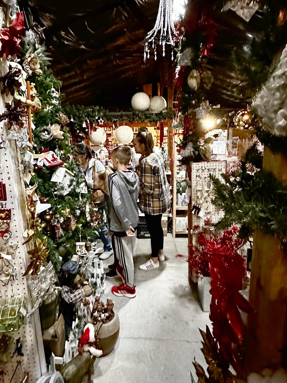 Customers browse the aisles of ornament displays at Ku-Tips Nursery & Gift Shop in Farmington, where it's Christmas all year.