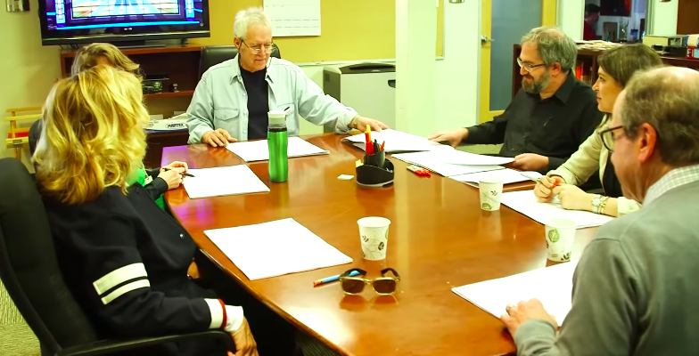 Alex Trebek sitting down with writers of "Jeopardy!"