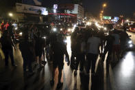 Anti-government protesters block a main highway during a demonstration against deteriorating economic conditions as politicians are deadlocked over forming a new government, in the town of Jal el-Dib, north of Beirut, Lebanon, Sunday, Sept. 27, 2020. Lebanese Prime Minister-designate Mustapha Adib resigned Saturday amid a political impasse over government formation, dealing a blow to French President Emmanuel Macron's efforts to break a dangerous stalemate in the crisis-hit country. (AP Photo/Bilal Hussein)