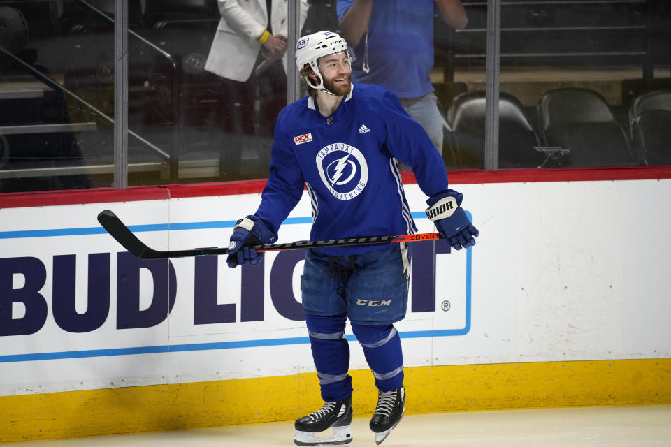 Tampa Bay Lightning center Brayden Point jokes with teammates during an NHL hockey practice before Game 1 of the Stanley Cup Finals, Tuesday, June 14, 2022, in Denver. (AP Photo/David Zalubowski)