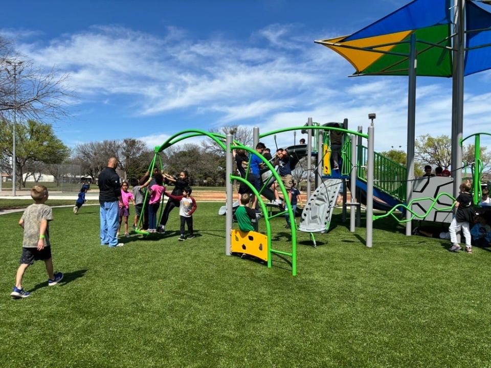 Children in the Speedway Spring Break Camp break in the new playground following the ribbon cutting ceremony at Arthur Sears Park, 2250 Ambler Avenue, on Wednesday, March 13, 2024.