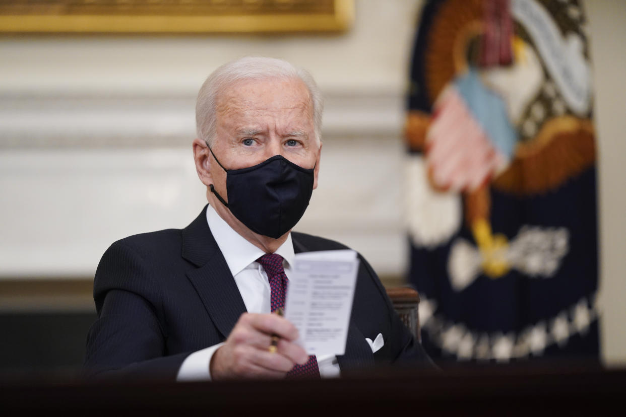 FILE - In this March 5, 2021, file photo, President Joe Biden participates in a roundtable discussion on a coronavirus relief package in the State Dining Room of the White House in Washington. Biden laid out an ambitious agenda for his first 100 days in office, promising swift action on everything from climate change to immigration reform to the coronavirus pandemic. (AP Photo/Patrick Semansky, File)