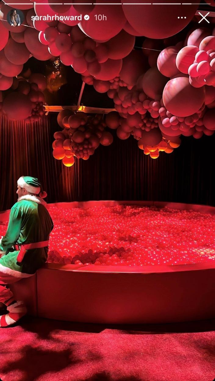 ball pit with only red balls and a Christmas elf at Kardashian Christmas Eve Party