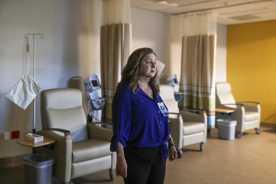 A woman stands in a large room.