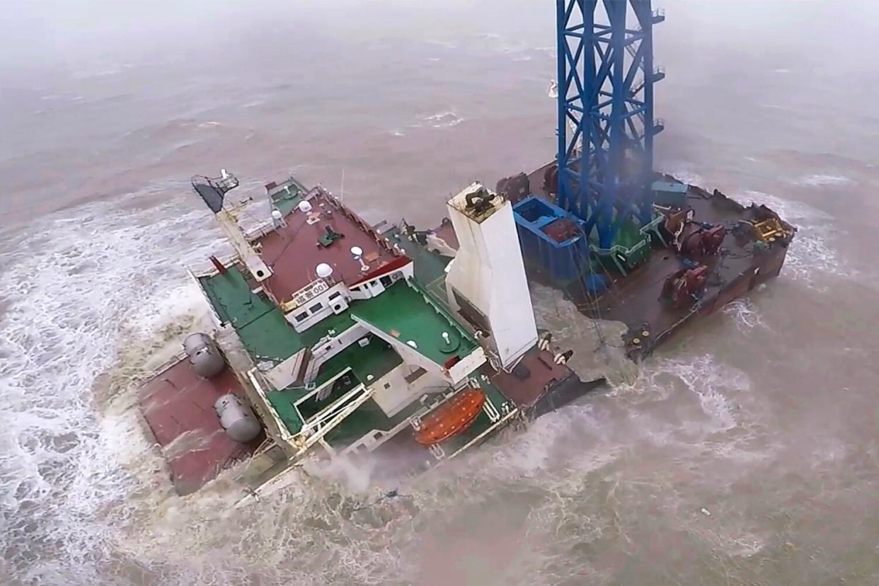 In this image released by Hong Kong Government Flying Service, a helicopter with rescue crew members approaches a sinking ship in the South China Sea, 300 kilometers (186 miles) south of Hong Kong on July 2, 2022, as Typhoon Chaba was moving in the area. A fourth crew member has been rescued Monday, July 4, 2022 after the typhoon sunk the engineering vessel earlier this week, according to a Chinese state broadcaster.