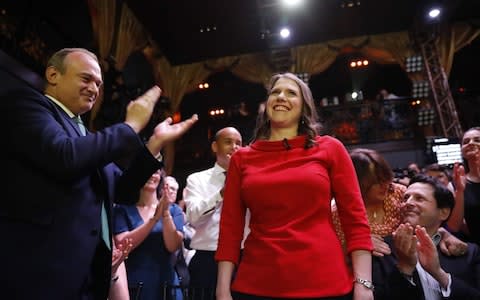 Jo Swinson is applauded by her husband (right) after her victory in the leadership contest - Credit: TOLGA AKMEN/AFP