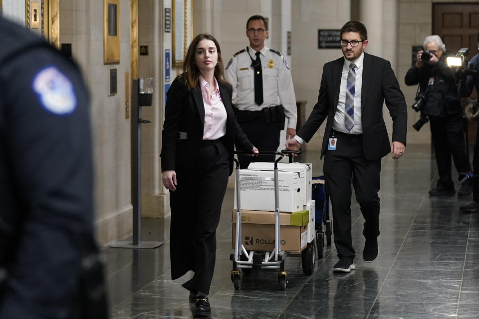 Documents arrive as the House Ways & Means Committee holds a hearing regarding tax returns from former President Donald Trump on Capitol Hill in Washington, Tuesday, Dec. 20, 2022. (AP Photo/Andrew Harnik)