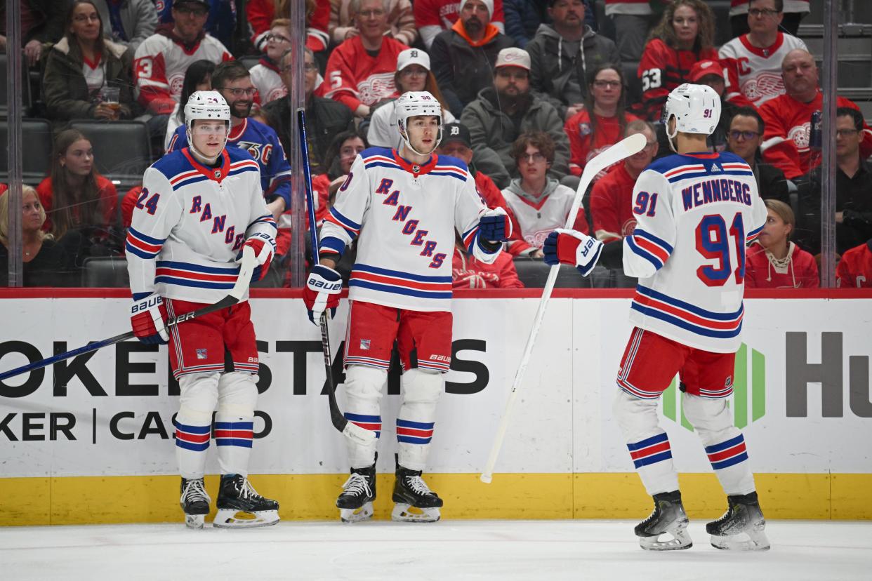 Apr 5, 2024; Detroit, Michigan, USA; New York Rangers left wing Will Cuylle (50) celebrates his with right wing Kaapo Kakko (24) and center Alex Wennberg (91) during the first period against the Detroit Red Wings at Little Caesars Arena.