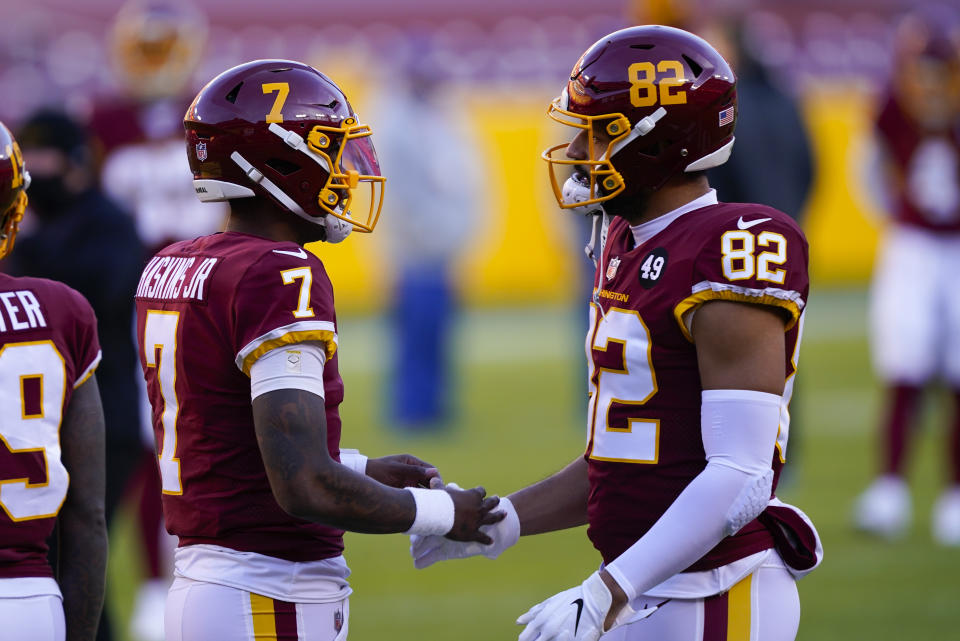 Washington Football Team quarterback Dwayne Haskins (7) greets teammate tight end Logan Thomas (82) before the start of an NFL football game against the Carolina Panthers, Sunday, Dec. 27, 2020, in Landover, Md. (AP Photo/Susan Walsh)