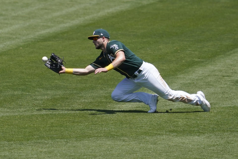Oakland Athletics right fielder Seth Brown catches a line out hit by Texas Rangers' Andy Ibanez during the third inning of a baseball game in Oakland, Calif., Thursday, July 1, 2021. (AP Photo/Jeff Chiu)