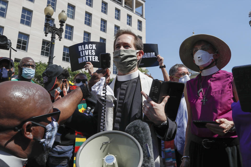 Rev. Rob Fisher, rector of St. John's Church, speaks Wednesday about a block from the church near the White House after a security perimeter prevented access to the church property itself. (Photo: Alex Brandon/Associated Press)