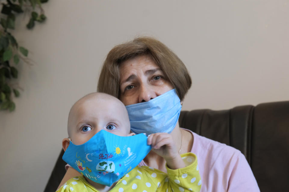A Ukrainian grandmother holds her 22-month-old granddaughter with leukemia, Yeva Vakulenko, at a clinic in Bocheniec, Poland, on Thursday, March 17, 2022. Vakulenko is among more than 500 Ukrainian children with cancer who have been evacuated so far to a clinic in Poland. They are evaluated by doctors who then decide where they should go next for treatment. Some 200 hospitals in 28 countries are accepting the children. (AP Photo/Pawel Kuczynski)