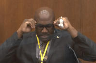 In this image from video, Philonise Floyd, brother of George Floyd, becomes emotional as he testifies as Hennepin County Judge Peter Cahill presides over court Monday, April 12, 2021, in the trial of former Minneapolis police Officer Derek Chauvin, in the May 25, 2020, death of George Floyd at the Hennepin County Courthouse in Minneapolis, Minn. (Court TV via AP, Pool)