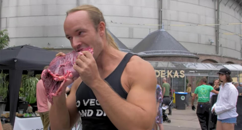 The pro-meat protester was filmed eating a hunk of raw meat at a vegan festival in Amsterdam, to wind up attendees