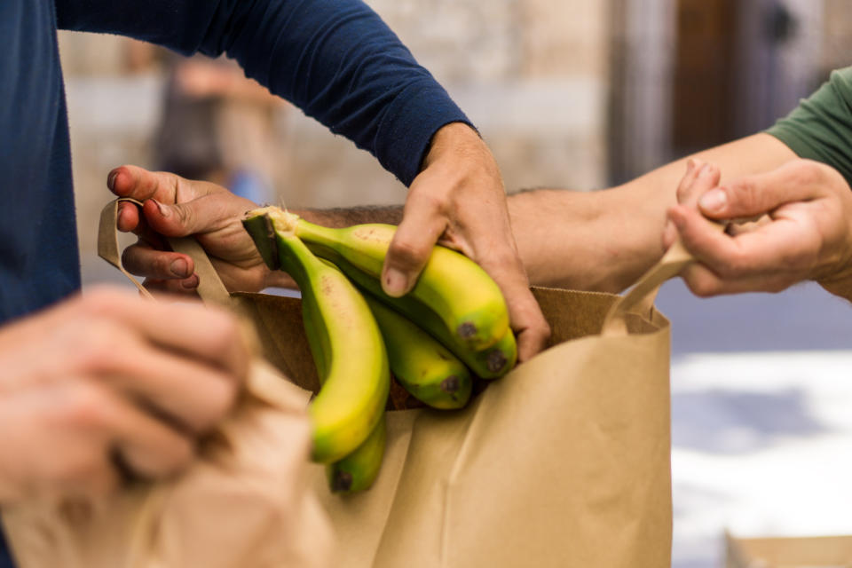 People bagging groceries