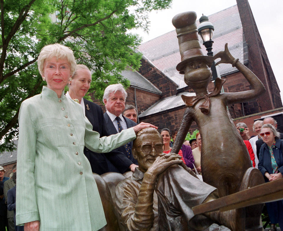 FILE - In this May 31, 2002 file photo, Audry Geisel, widow of Theodore Geisel, better known as children's book author Dr. Seuss, places her hand on the head of a just-unveiled sculpture of the writer next to his character, The Cat in the Hat, in Springfield, Mass. The Seuss memorial, located in Geisel's hometown, was created by his step-daughter, Lark Grey Dimond-Cates, second from left, with Sen. Edward M. Kennedy, D-Mass., third from left. Audrey Geisel died peacefully at her La Jolla, Calif., home on Wednesday, Dec. 19, 2018, at age 97. (AP Photo/Nancy Palmieri, File)