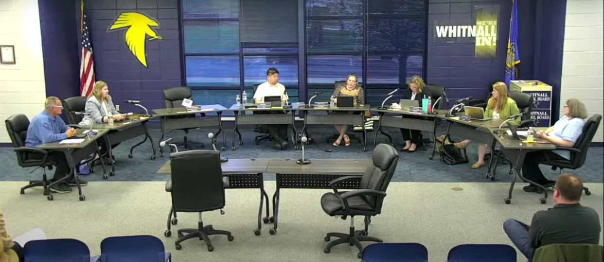 Whitnall School Board member Rachel Scherrer (right center) reads a statement at the board's April 22 meeting claiming some board members and community members had made phone calls and sent text messages and Facebook messages to her, some of which she saw as threatening and intimidating.