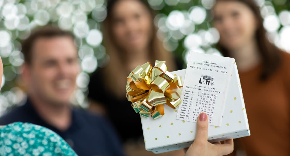 A lotto ticket and people in the background