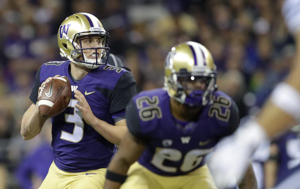 Washington quarterback Jake Browning looks to pass behind running back Salvon Ahmed during the second against BYU on Saturday in Seattle. (AP Photo/Ted S. Warren)