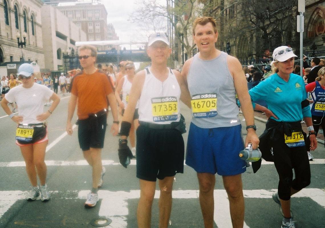 Bob Mueller, right, stands at the finish line of the Boston Marathon with friend Jim Szyjakowski in 2010. In January, Mueller finished his goal of running a marathon in every U.S. state.